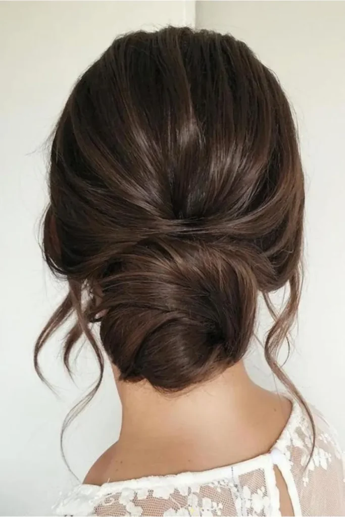 Low Messy Bun with Soft Tendrils 